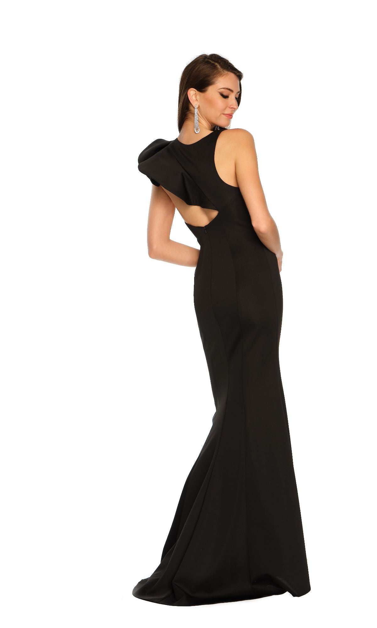 A woman models the Long Formal Dress 11311 by Dave and Johnny—black, fitted, with an asymmetric cut-out and open back—standing against a plain white background.